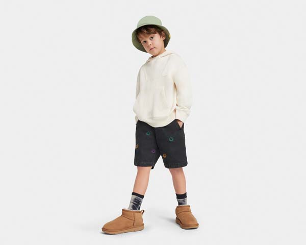 Kid standing in UGG shoes.