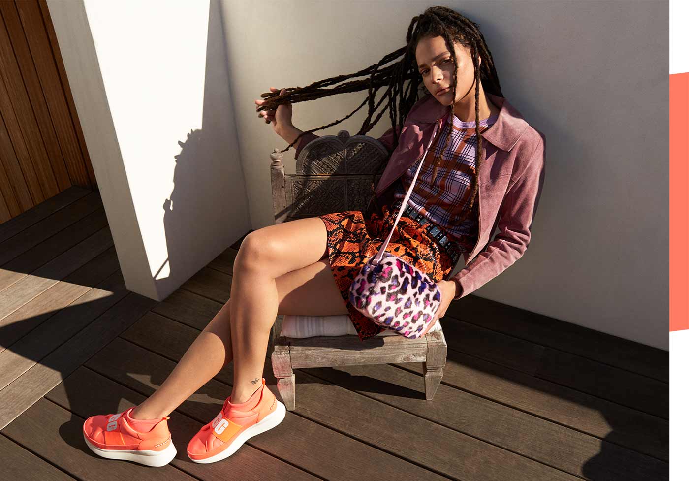 Woman wearing Neon Neutra Sneakers sitting on a chair.