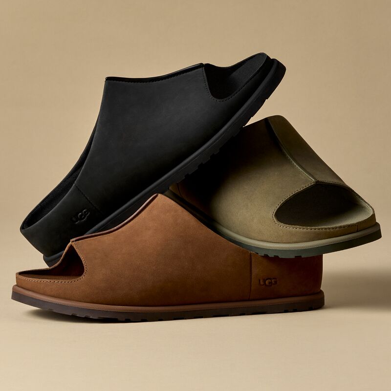 The UGG Otzo Slide, in 3 neutral, earthy color ways, against a beige backdrop.