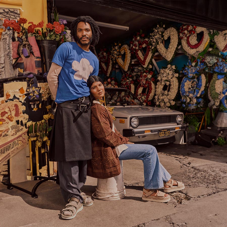 A lifestyle image of a man wearing the Goldencoast Multistrap and a woman wearing the Goldenstar Sandal.