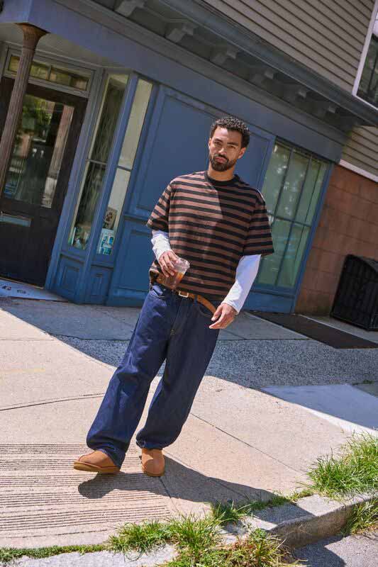 A masculine person wearing the new UGG Tasman II shoes and a complimentary, fall fit.