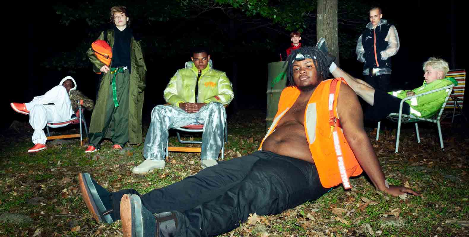 Group of boys lounging in the woods.