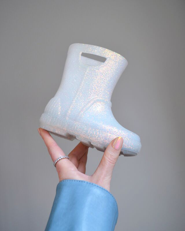 A detail shot of a sparkly kids' UGG boot.