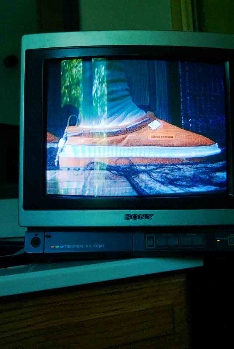 Close-up of the UGG X HP Tasman in orange on a CRTV.