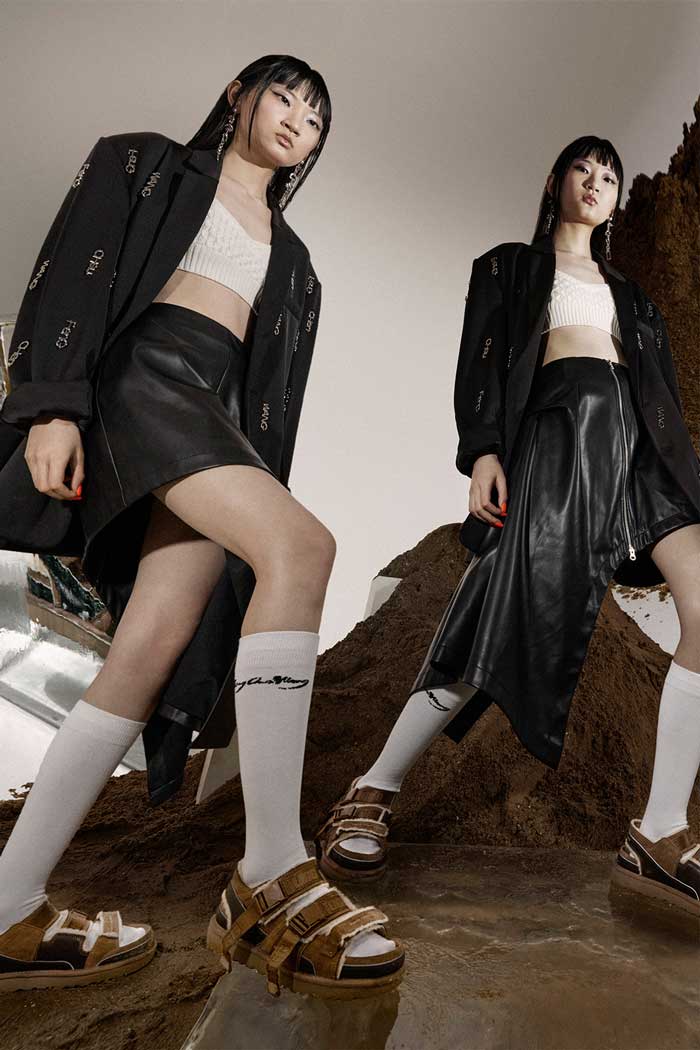 Models on a mound of dirt and block ice wearing UGG boots by Feng Chen Wang.